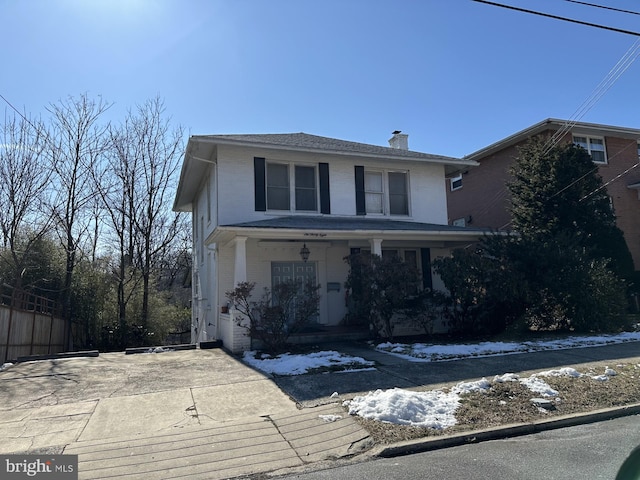 638 Washington St, Cumberland, MD 21502 - traditional style home featuring a chimney, brick siding, a porch, and driveway