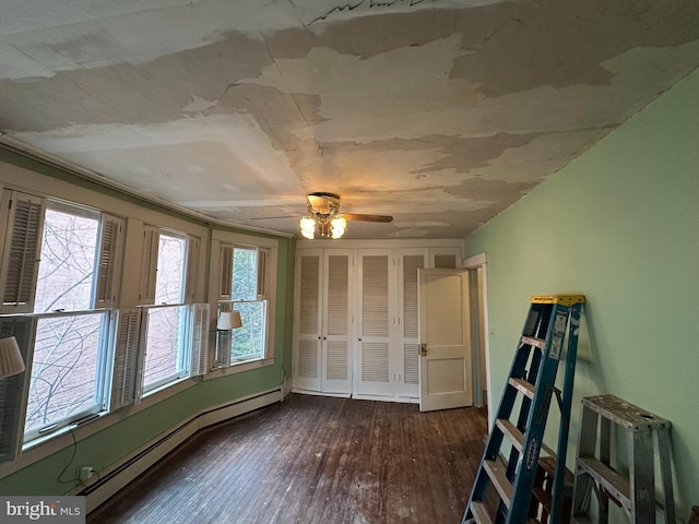 638 Washington St, Cumberland, MD 21502 - unfurnished bedroom featuring a baseboard radiator, hardwood / wood-style flooring, a closet, and a ceiling fan