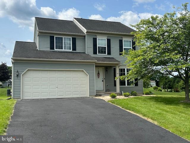 69 Geisinger Ln, Lewistown, PA 17044 - view of front of home featuring asphalt driveway, a front yard, and a garage