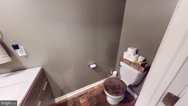 69 Geisinger Ln, Lewistown, PA 17044 - bathroom with toilet, vanity, wood finished floors, and baseboards
