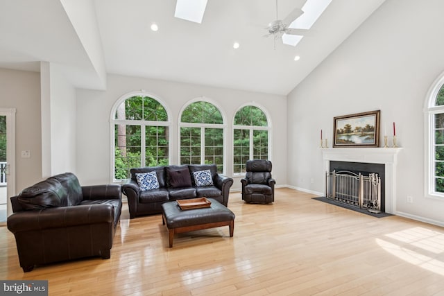2 Teaberry Ct, Shamong, NJ 08088 - living room featuring a skylight, high vaulted ceiling, light wood finished floors, a fireplace with flush hearth, and recessed lighting