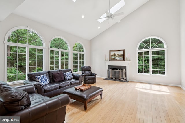 2 Teaberry Ct, Shamong, NJ 08088 - living area with high vaulted ceiling, a skylight, light wood finished floors, a fireplace with flush hearth, and recessed lighting