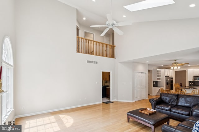 2 Teaberry Ct, Shamong, NJ 08088 - living room featuring a ceiling fan, a skylight, light wood finished floors, a high ceiling, and recessed lighting