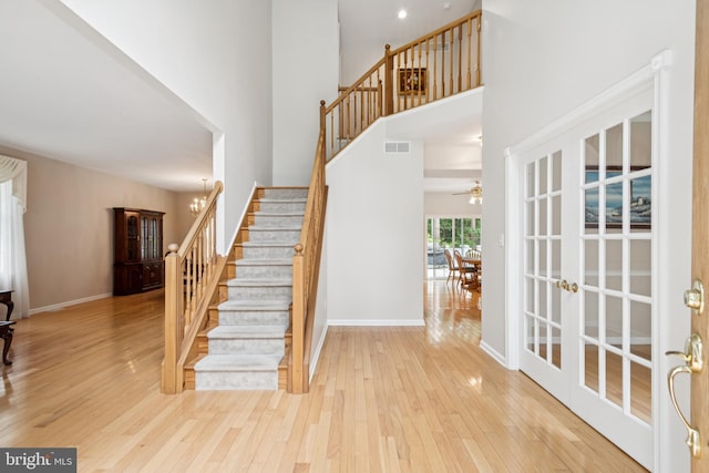 2 Teaberry Ct, Shamong, NJ 08088 - stairway featuring french doors, wood finished floors, a high ceiling, and ceiling fan