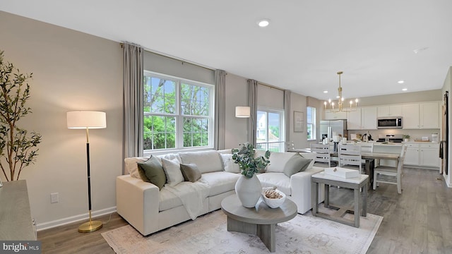 2041 Gregory Dr, Allentown, PA 18103 - living room featuring a chandelier, light wood finished floors, recessed lighting, and baseboards