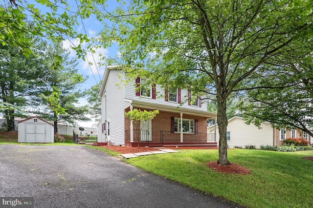 108 Oakmont Cir, Winchester, VA 22602 - traditional-style house with a shed, covered porch, brick siding, and a front lawn