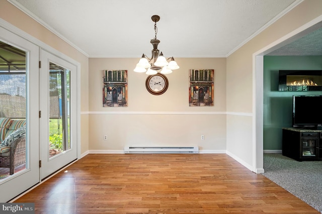 108 Oakmont Cir, Winchester, VA 22602 - unfurnished dining area featuring a baseboard radiator, a chandelier, crown molding, and wood finished floors