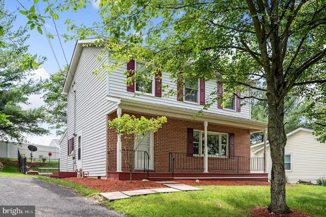 108 Oakmont Cir, Winchester, VA 22602 - view of front of house with a porch, a front lawn, and brick siding