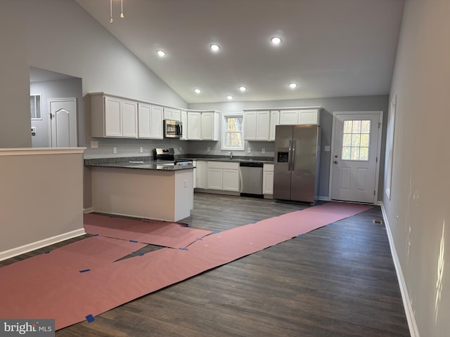 230 Spring Hollow Rd, Front Royal, VA 22630 - kitchen featuring stainless steel appliances, dark countertops, a peninsula, a sink, and dark wood-style floors