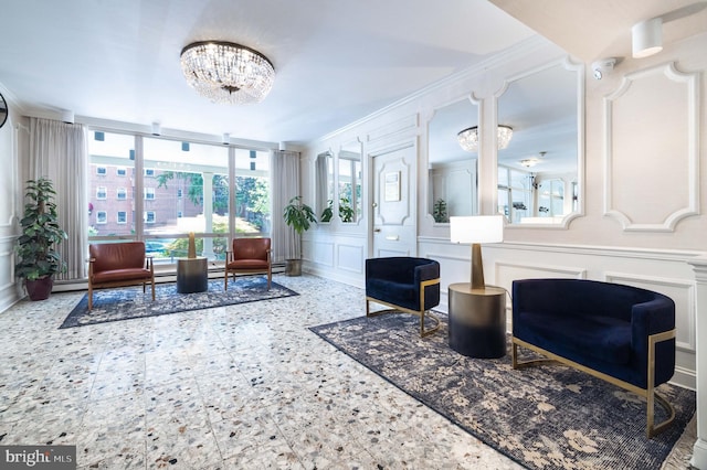 1301 N Harrison St Unit 1108, Wilmington, DE 19806 - living area featuring a decorative wall, a chandelier, ornamental molding, healthy amount of natural light, and a wainscoted wall