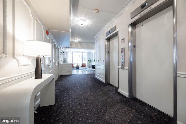 1301 N Harrison St Unit 1108, Wilmington, DE 19806 - hallway with elevator, a decorative wall, dark colored carpet, and crown molding