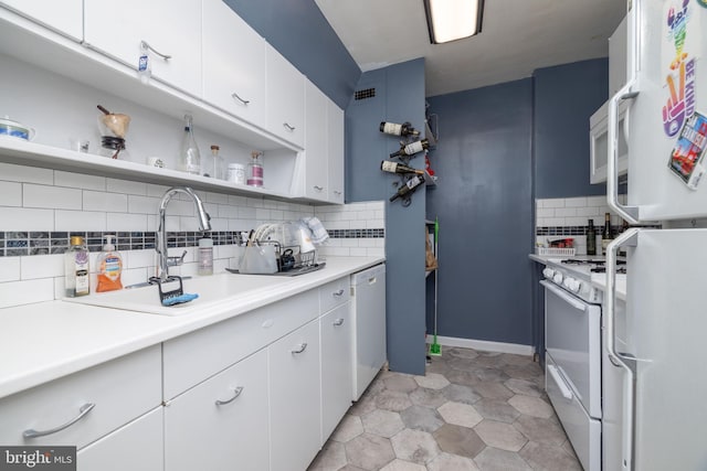 1301 N Harrison St Unit 1108, Wilmington, DE 19806 - kitchen with white appliances, tasteful backsplash, open shelves, a sink, and white cabinetry