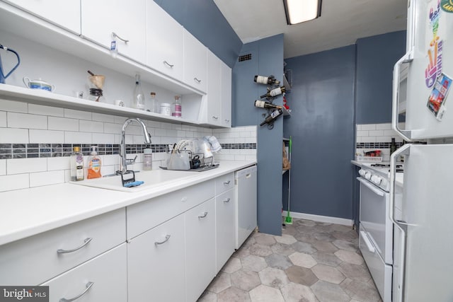 1301 N Harrison St Unit 1108, Wilmington, DE 19806 - kitchen with white appliances, open shelves, backsplash, a sink, and white cabinetry