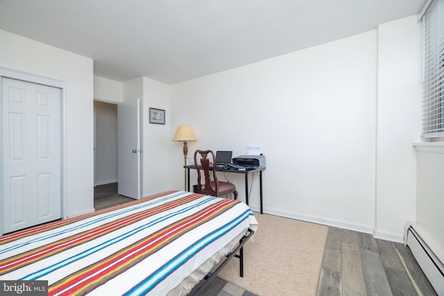 1301 N Harrison St Unit 1108, Wilmington, DE 19806 - bedroom featuring baseboard heating, wood finished floors, and baseboards