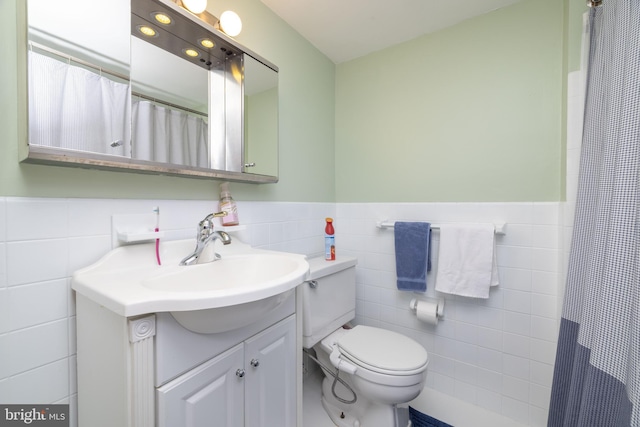 1301 N Harrison St Unit 1108, Wilmington, DE 19806 - bathroom with tile walls, vanity, toilet, a wainscoted wall, and a shower with shower curtain