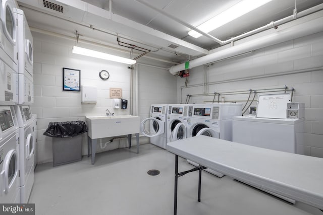 1301 N Harrison St Unit 1108, Wilmington, DE 19806 - community laundry with separate washer and dryer, stacked washer / dryer, and concrete block wall