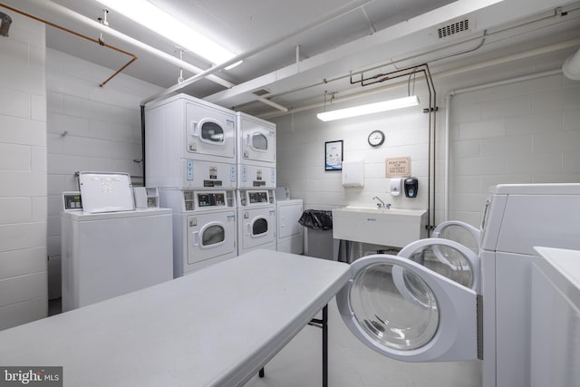 1301 N Harrison St Unit 1108, Wilmington, DE 19806 - shared laundry room with washing machine and dryer, estacked washer and dryer, and concrete block wall