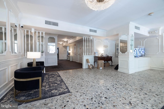 1301 N Harrison St Unit 1108, Wilmington, DE 19806 - foyer featuring a decorative wall, crown molding, a chandelier, and a wainscoted wall