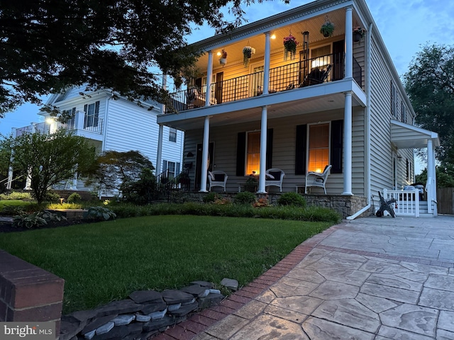 2606 Caroline St, Fredericksburg, VA 22401 - view of front of property featuring a balcony, covered porch, and a front lawn
