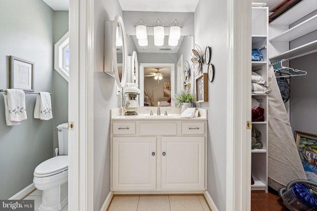 2606 Caroline St, Fredericksburg, VA 22401 - bathroom featuring vanity, toilet, baseboards, tile patterned floors, and a walk in closet