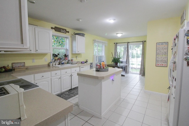 32530 Approach Unit 3252, Long Neck, DE 19966 - kitchen with white cabinetry, a center island, light countertops, and light tile patterned flooring