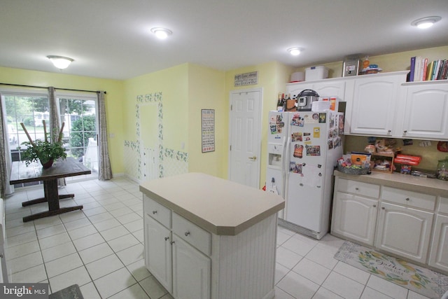 32530 Approach Unit 3252, Long Neck, DE 19966 - kitchen featuring white refrigerator with ice dispenser, light tile patterned floors, white cabinetry, a center island, and light countertops