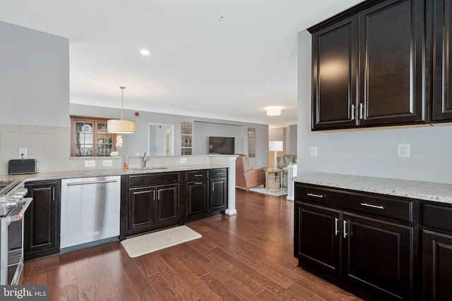 20620 Hope Spring Ter Unit 401, Ashburn, VA 20147 - kitchen featuring stainless steel appliances, a sink, open floor plan, a peninsula, and dark wood finished floors