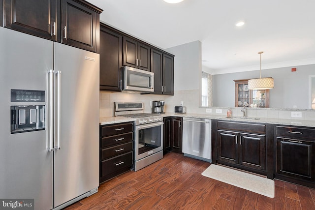 20620 Hope Spring Ter Unit 401, Ashburn, VA 20147 - kitchen with appliances with stainless steel finishes, a sink, dark wood-type flooring, light stone counters, and ornamental molding