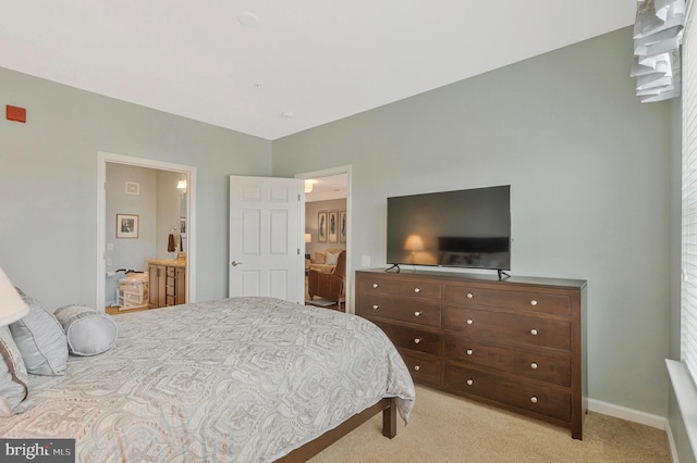 20620 Hope Spring Ter Unit 401, Ashburn, VA 20147 - bedroom featuring light carpet, baseboards, and connected bathroom
