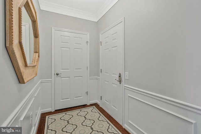 20620 Hope Spring Ter Unit 401, Ashburn, VA 20147 - doorway with crown molding, dark wood finished floors, a wainscoted wall, and a decorative wall