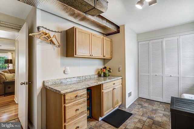 5901 Wivenhoe Ct, Alexandria, VA 22315 - kitchen featuring light brown cabinetry, stone finish flooring, and baseboards
