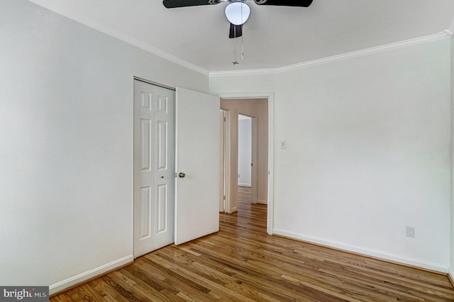 5901 Wivenhoe Ct, Alexandria, VA 22315 - unfurnished bedroom with wood finished floors, crown molding, baseboards, a closet, and a ceiling fan