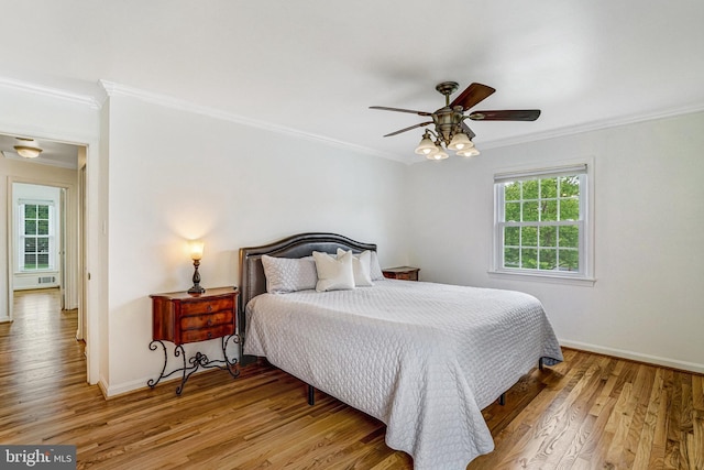 5901 Wivenhoe Ct, Alexandria, VA 22315 - bedroom featuring crown molding, light wood-style flooring, baseboards, and a ceiling fan