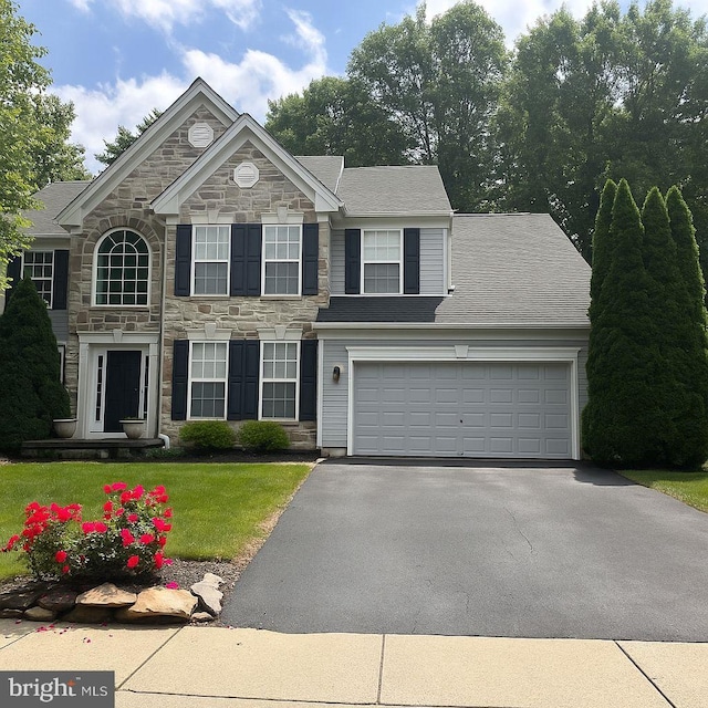 101 Glencoe Ct, Newark, DE 19702 - view of front of home featuring stone siding, asphalt driveway, a front yard, an attached garage, and roof with shingles