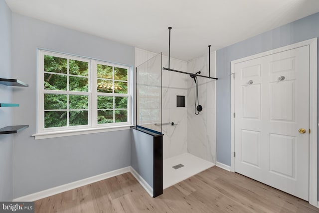101 Glencoe Ct, Newark, DE 19702 - bathroom featuring healthy amount of natural light, a marble finish shower, wood finished floors, and baseboards