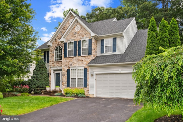 101 Glencoe Ct, Newark, DE 19702 - view of front facade with stone siding, asphalt driveway, a shingled roof, an attached garage, and a front yard