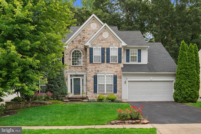 101 Glencoe Ct, Newark, DE 19702 - view of front facade with stone siding, driveway, a front lawn, roof with shingles, and a garage
