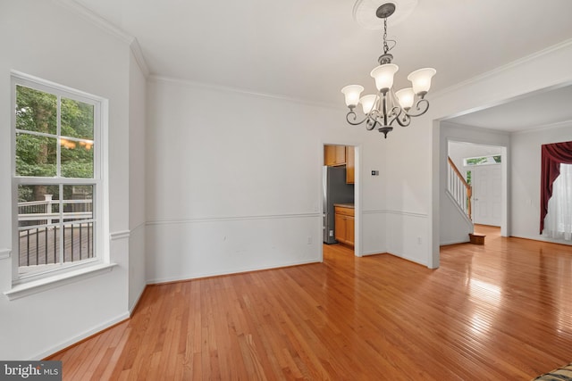 101 Glencoe Ct, Newark, DE 19702 - unfurnished dining area with a chandelier, light wood-style flooring, ornamental molding, stairway, and baseboards