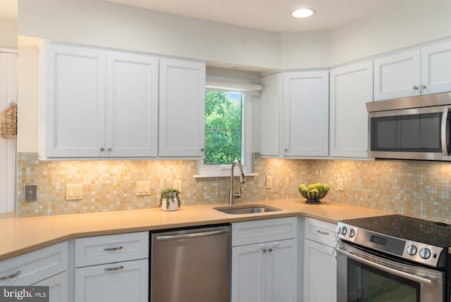 2657 Carrollton Rd, Annapolis, MD 21403 - kitchen featuring stainless steel appliances, light countertops, white cabinetry, and decorative backsplash