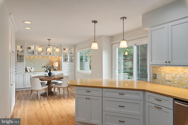 2657 Carrollton Rd, Annapolis, MD 21403 - kitchen featuring backsplash, light countertops, light wood-style floors, decorative light fixtures, and stainless steel dishwasher
