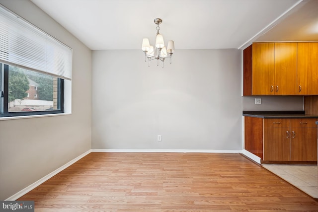 8601 Manchester Rd Unit 319, Silver Spring, MD 20901 - unfurnished dining area featuring a chandelier and light wood-style flooring