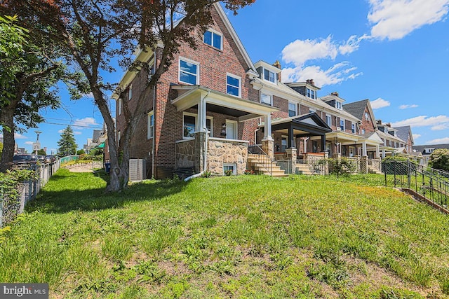 4116 Edmondson Ave, Baltimore, MD 21229 - rear view of property featuring brick siding, a porch, and central air condition unit