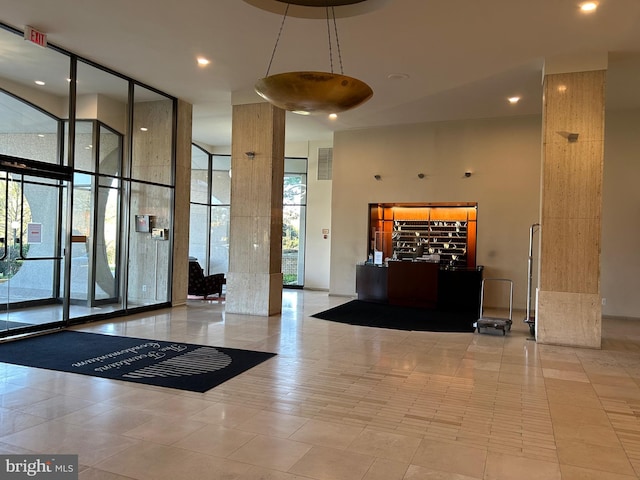 301 N Beauregard St Unit 320, Alexandria, VA 22312 - building lobby featuring a high ceiling, a wall of windows, and recessed lighting
