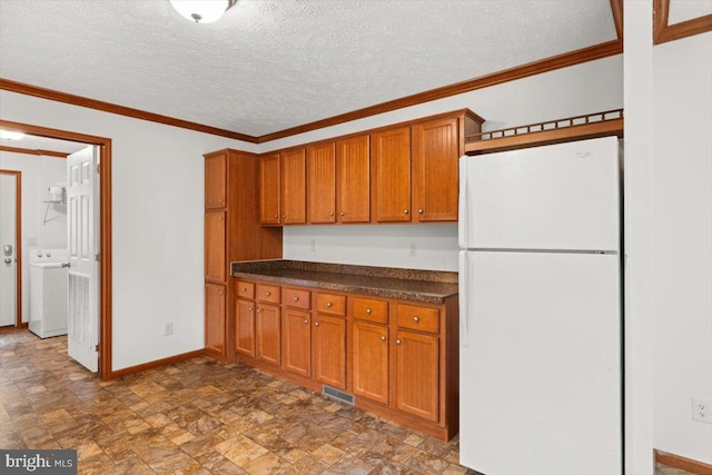 4767 S Ox Rd, Edinburg, VA 22824 - kitchen with freestanding refrigerator, brown cabinets, dark countertops, stone finish flooring, and a textured ceiling