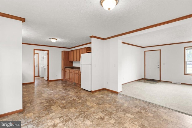 4767 S Ox Rd, Edinburg, VA 22824 - kitchen with freestanding refrigerator, stone finish flooring, brown cabinetry, a textured ceiling, and ornamental molding