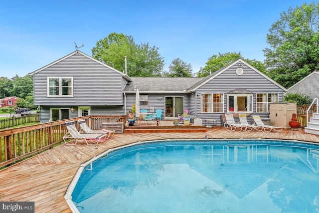 111 Sue Ann Ct, Sterling, VA 20164 - back of property featuring a wooden deck, an outdoor pool, and a shingled roof
