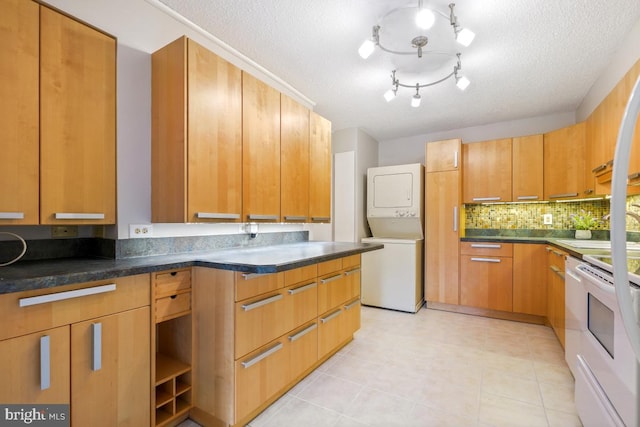 5902 Mount Eagle Dr Unit 718, Alexandria, VA 22303 - kitchen featuring stacked washer and clothes dryer, dark countertops, decorative backsplash, a textured ceiling, and brown cabinetry