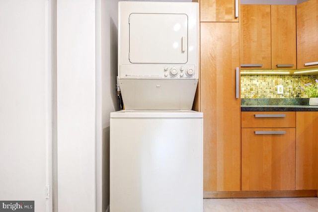 5902 Mount Eagle Dr Unit 718, Alexandria, VA 22303 - laundry area with stacked washer / dryer and light tile patterned flooring