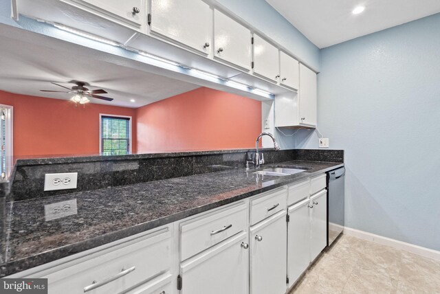 3315 Wyndham Cir Unit 1223, Alexandria, VA 22302 - kitchen featuring dishwasher, white cabinets, a sink, a ceiling fan, and dark stone countertops