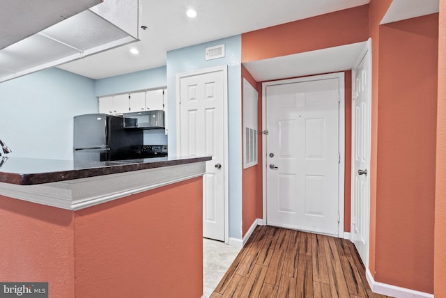 3315 Wyndham Cir Unit 1223, Alexandria, VA 22302 - kitchen featuring black appliances, light wood-style floors, baseboards, recessed lighting, and white cabinetry